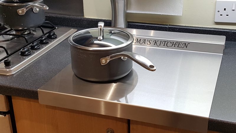 Personalised stainless steel worktop saver.